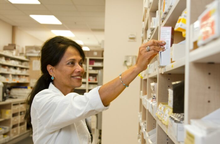 Pharmacist looking for medication on a shelf